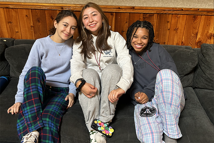 Photo of three teen girls sitting on a sofa at the Teen Jews of Color Fellowship